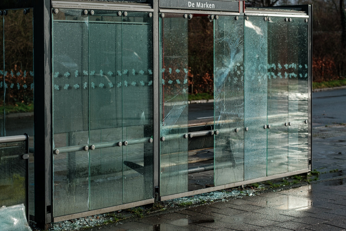 a broken glass door on the side of a building